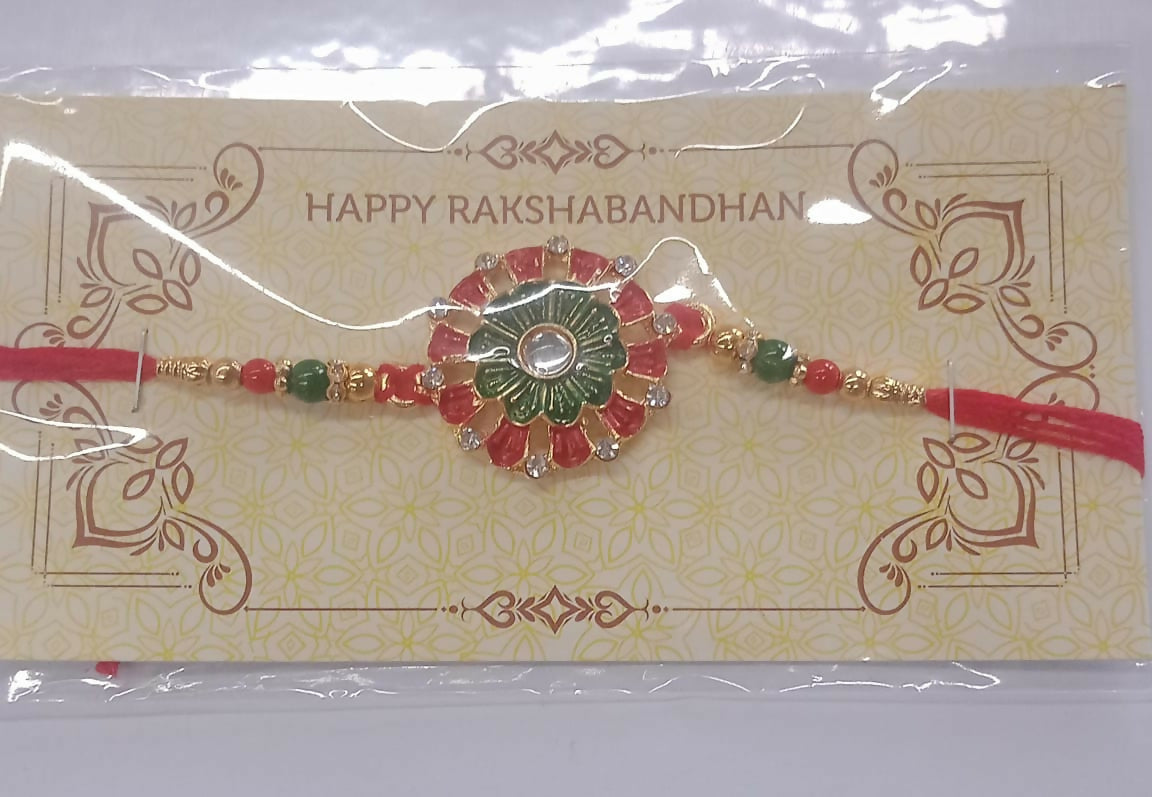 Traditional Rakhi With Floral Centerpiece Red Green Beads And Stone Embellishments On Red Thread