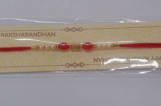 Traditional Pearl Beaded Rakhi With Red Beads  Golden Accents  Elegant Raksha Bandhan Thread For Brother