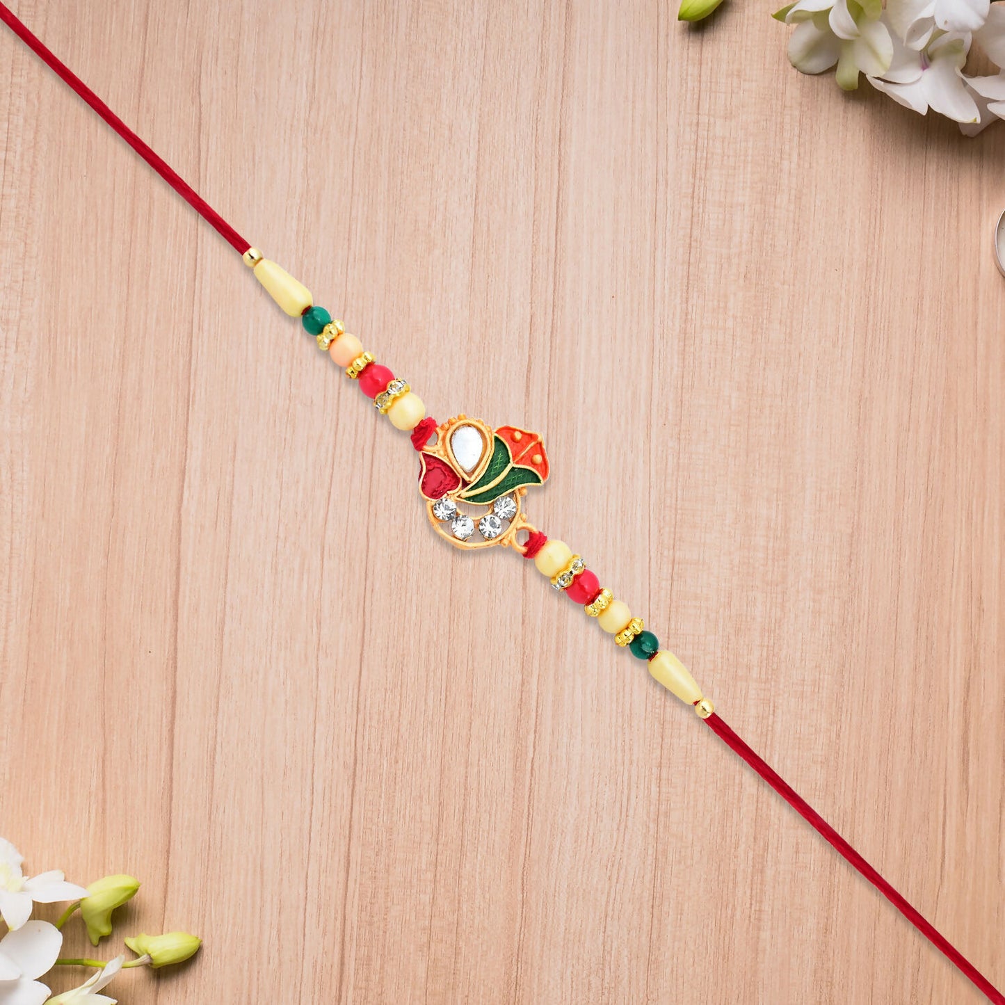 Divine Ganpati Rakhi With Enamel Work And Traditional Beads