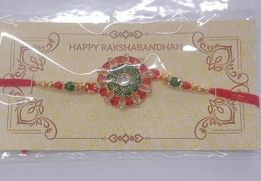 Traditional Rakhi With Floral Centerpiece Red Green Beads And Stone Embellishments On Red Thread