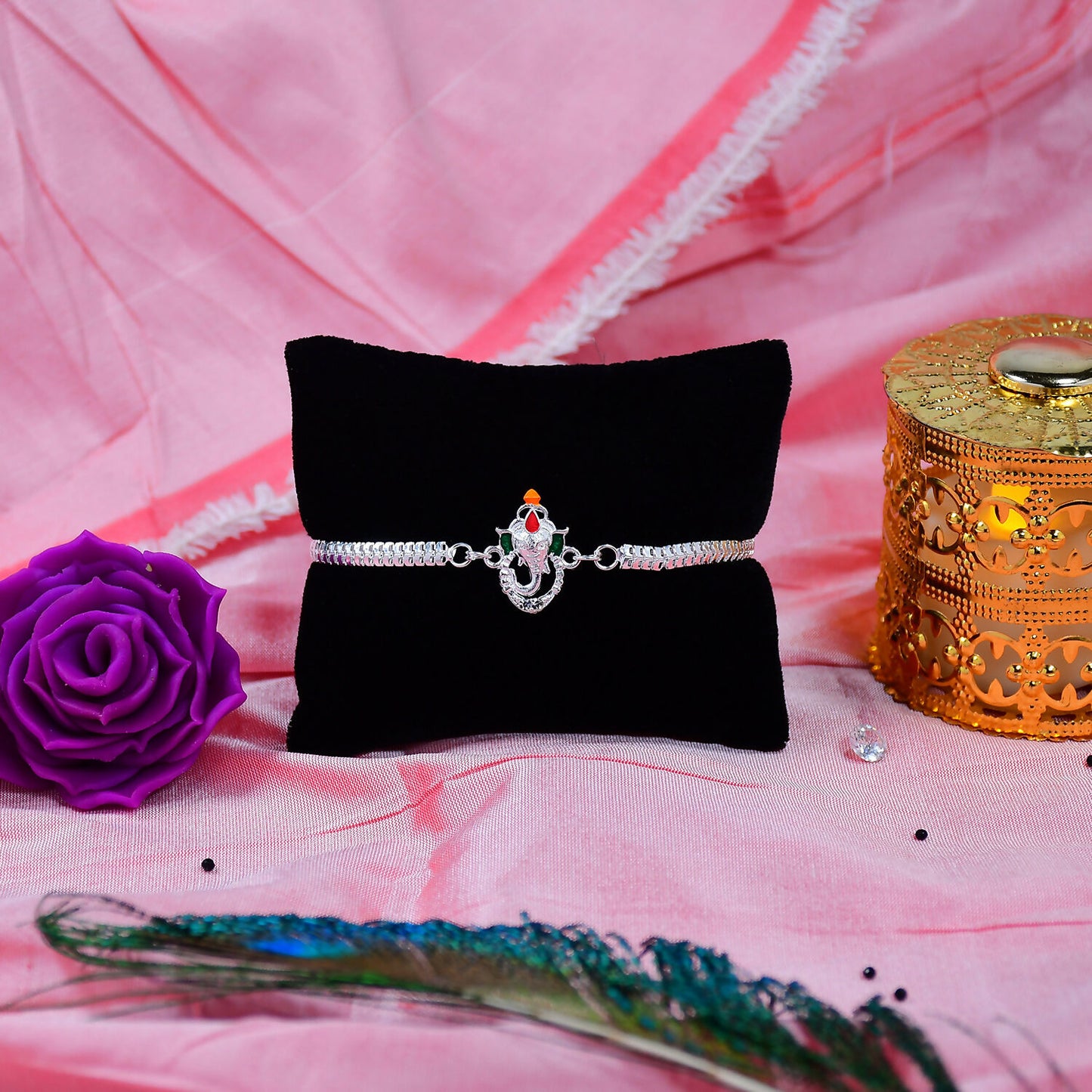 Stylish Ganesha Rakhi With Enamel Highlights And Silver Metal Chainstylish Ganesha Rakhi With Enamel Highlights And Silver Metal Chain