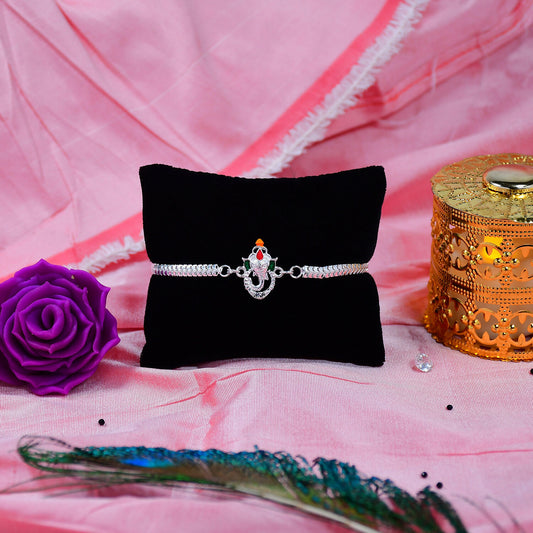 Stylish Ganesha Rakhi With Enamel Highlights And Silver Metal Chainstylish Ganesha Rakhi With Enamel Highlights And Silver Metal Chain