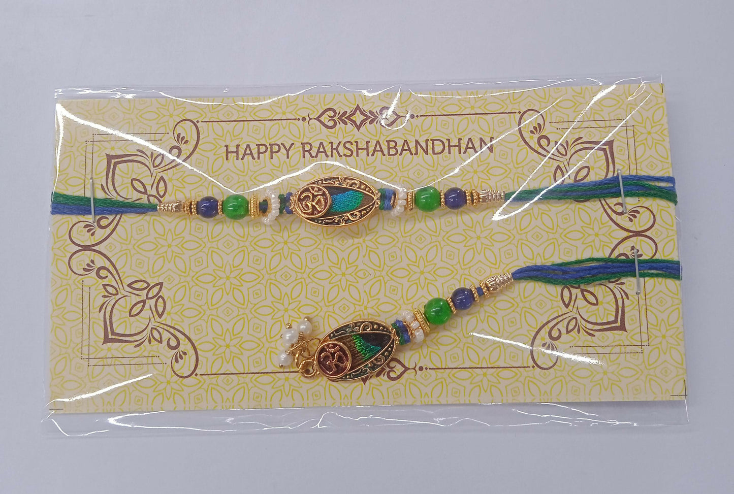 Bhaiya Bhabhi Rakhi Set With Om Symbol And Multicolor Beads In Traditional Thread Design